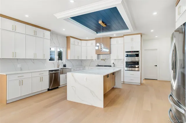 a kitchen with granite countertop white cabinets and white appliances