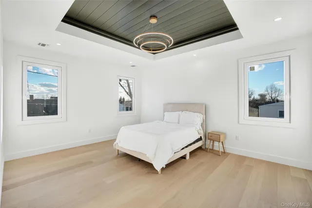 a spacious bedroom with a bed and a window