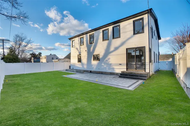 a view of a house with a backyard porch and sitting area