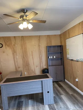 a kitchen with a wooden floor and cabinets