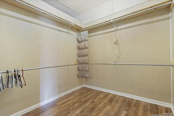 a view of a room with wooden floor