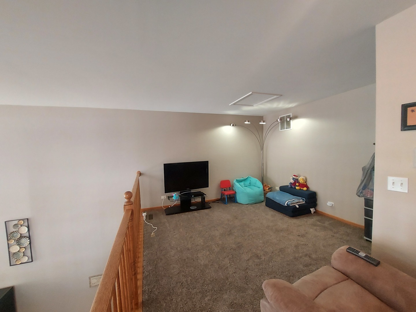 1022 Eineke Boulevard, Unit 1022 Algonquin, IL 60102 - Photo 14 of 18 a living room with furniture and a flat screen tv