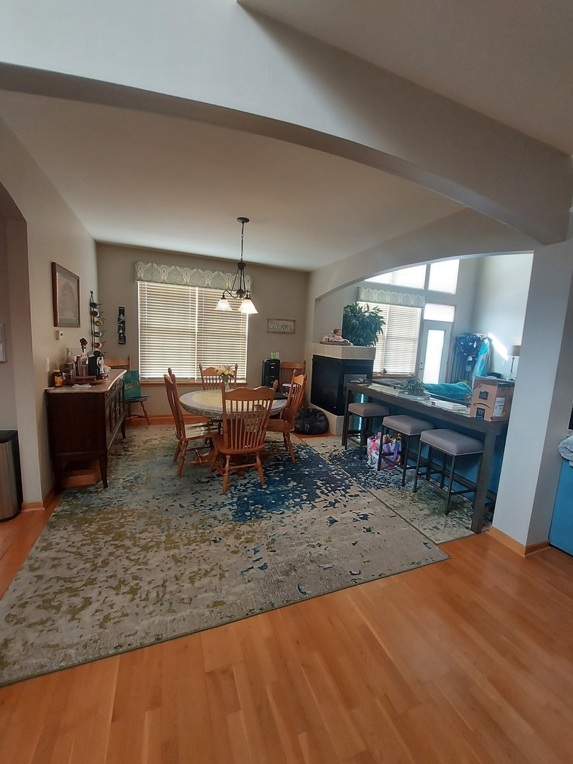 1022 Eineke Boulevard, Unit 1022 Algonquin, IL 60102 - Photo 5 of 18 a view of a dining room with furniture a rug and wooden floor