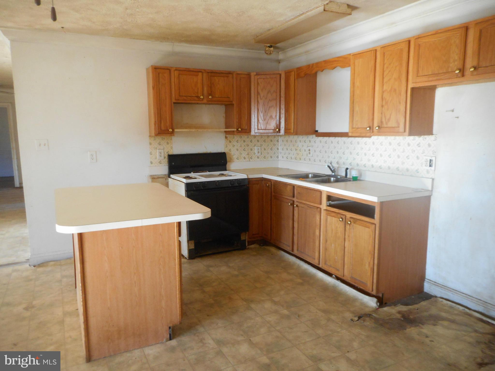 2313 Wingate Bishops Head Road Wingate, MD 21675 - Photo 3 of 18 a kitchen with stainless steel appliances a sink a stove a refrigerator a microwave a sink and cabinets