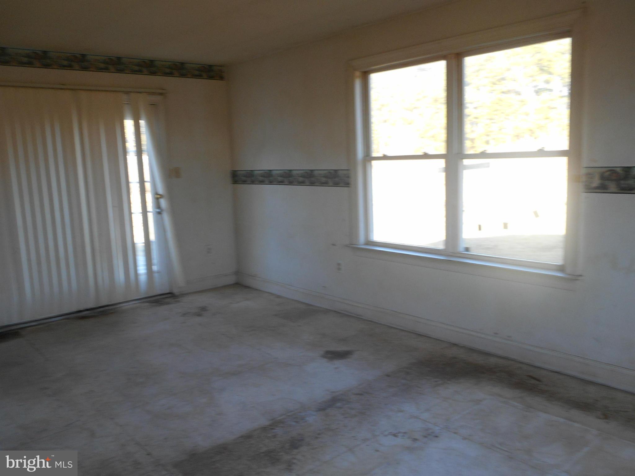 2313 Wingate Bishops Head Road Wingate, MD 21675 - Photo 5 of 18 an empty room with a empty space and windows