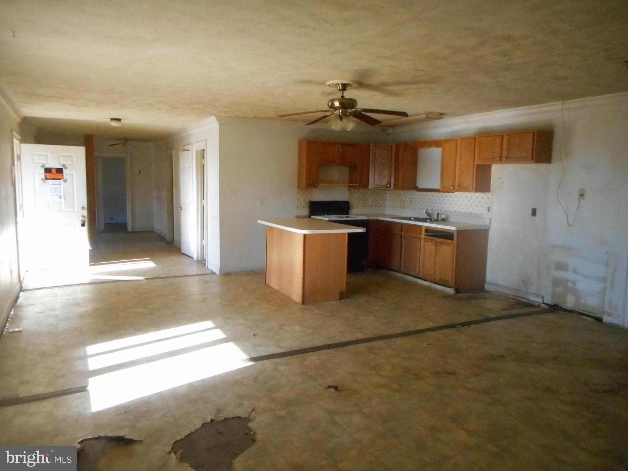 2313 Wingate Bishops Head Road Wingate, MD 21675 - Photo 8 of 18 a view of a kitchen with a stove cabinets and a floor to ceiling window