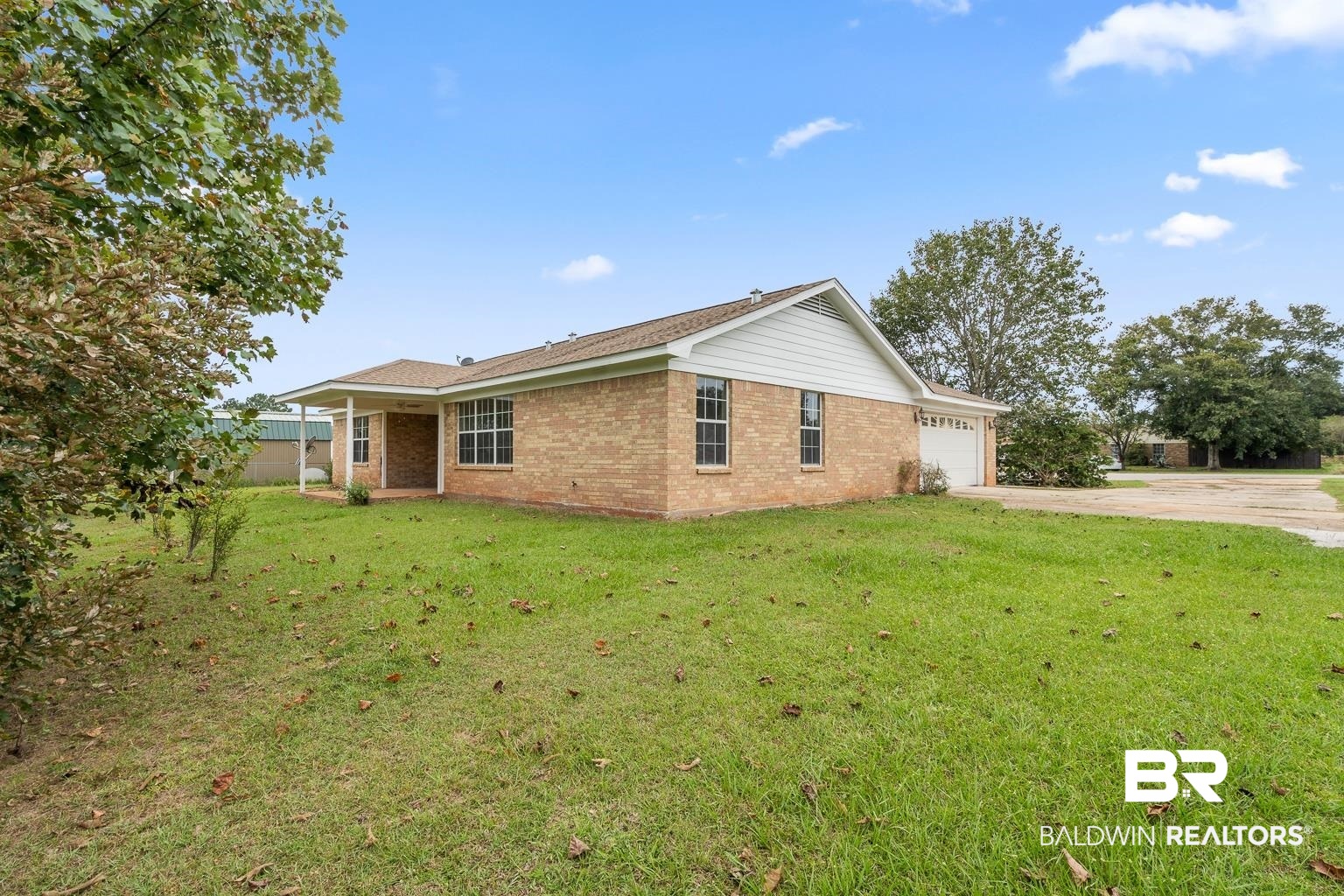 16418 Avent Lane Foley, AL 36535 - Photo 5 of 30 View of property exterior with a garage and a lawn