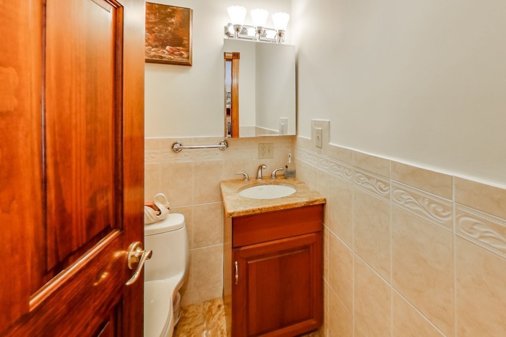 131 Range Heights Road Lynn, MA 01904 - Photo 12 of 30 a bathroom with a sink a mirror and a shower