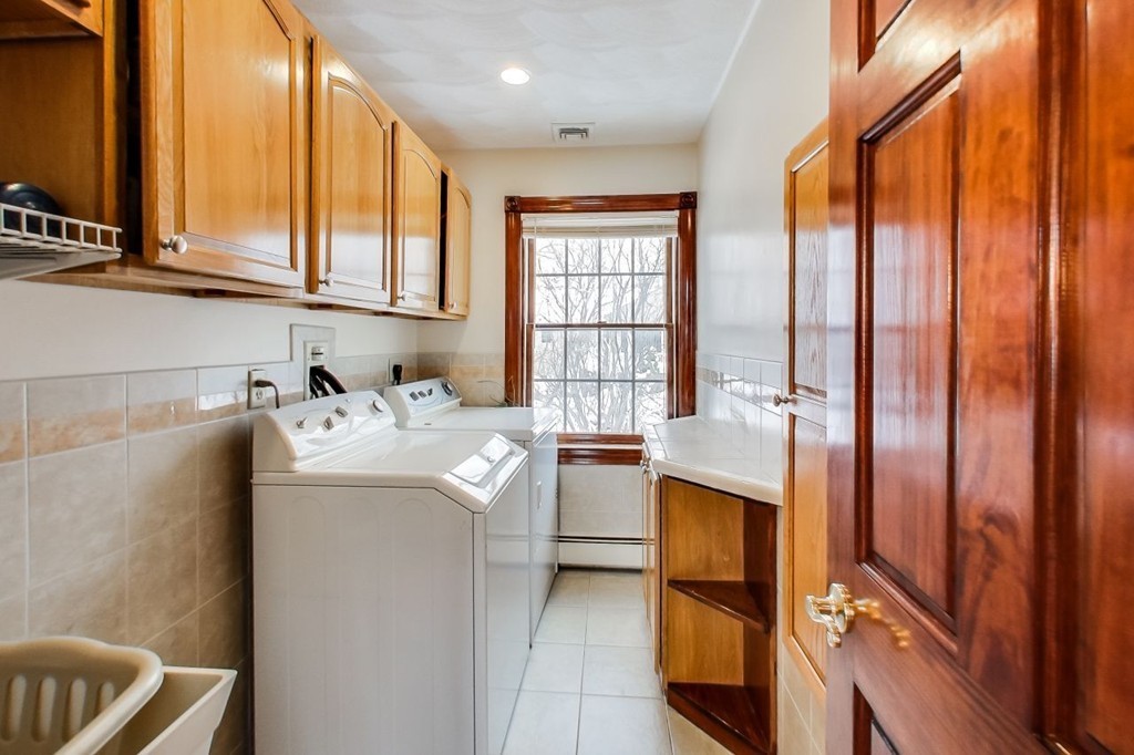 131 Range Heights Road Lynn, MA 01904 - Photo 18 of 30 a kitchen with stainless steel appliances granite countertop a refrigerator a sink and white cabinets with wooden floor