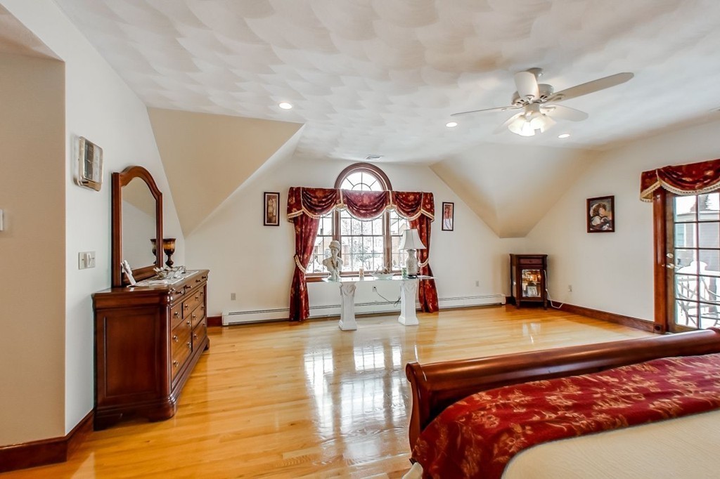 131 Range Heights Road Lynn, MA 01904 - Photo 21 of 30 a bedroom with a bed a dresser and flat screen tv