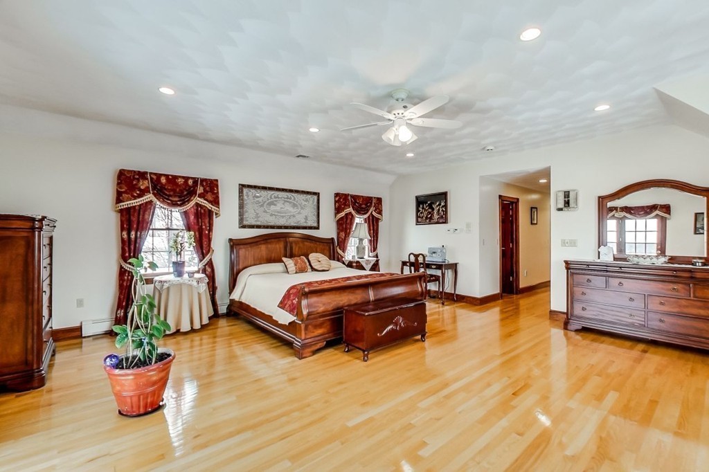 131 Range Heights Road Lynn, MA 01904 - Photo 22 of 30 a spacious bedroom with a bed and wooden floor
