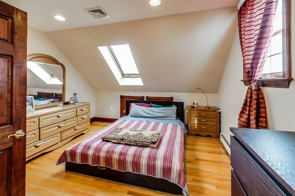 131 Range Heights Road Lynn, MA 01904 - Photo 27 of 30 a bedroom with a bed and dresser with mirror