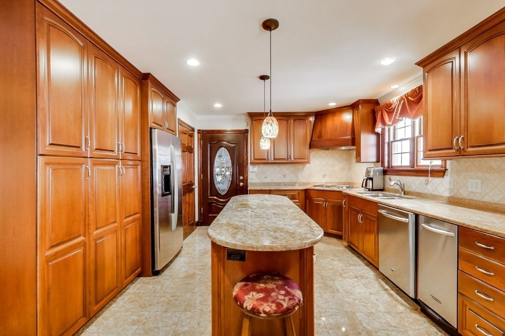 131 Range Heights Road Lynn, MA 01904 - Photo 9 of 30 a kitchen with stainless steel appliances granite countertop a refrigerator a sink and a stove