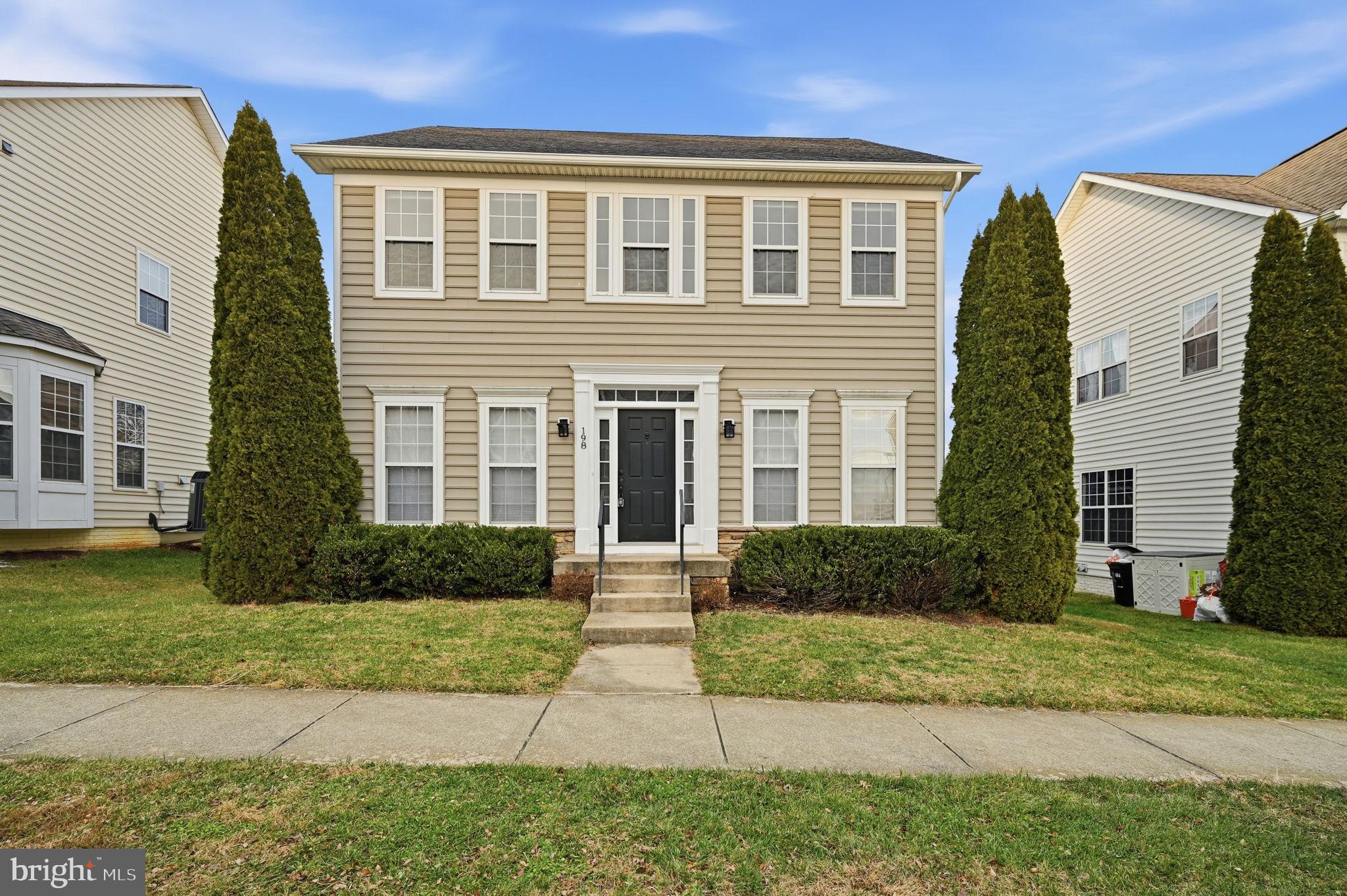 a front view of a house with a yard