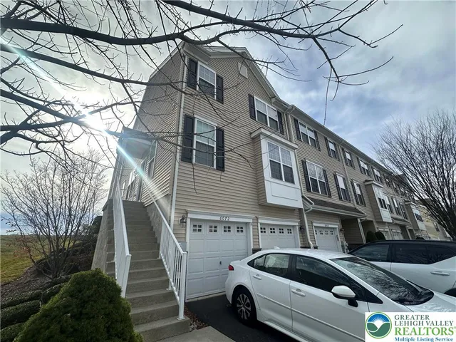 a view of a car park in front of a house