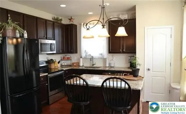 a kitchen with a refrigerator a sink dishwasher a stove and a refrigerator