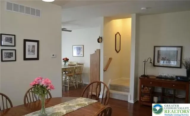 a dining room with furniture and wooden floor