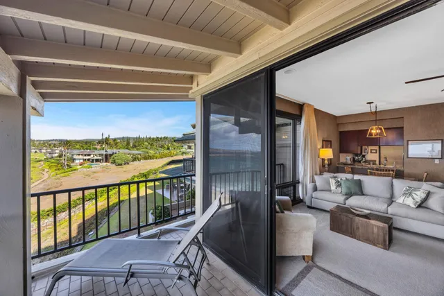 a living room with furniture a large window and table
