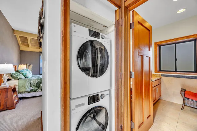 a view of staircase with lots of frames on wall and a window