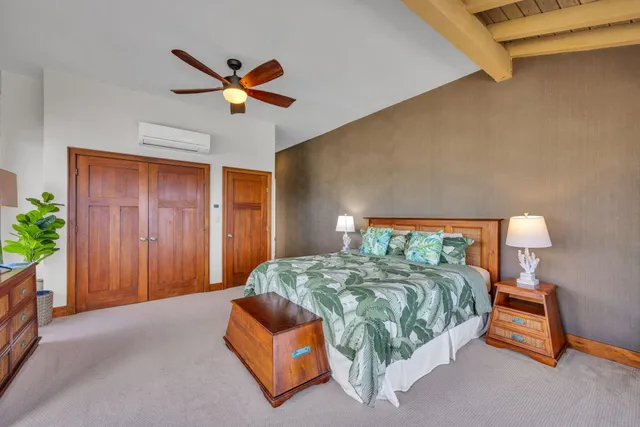 a large bed sitting in a bedroom next to a window