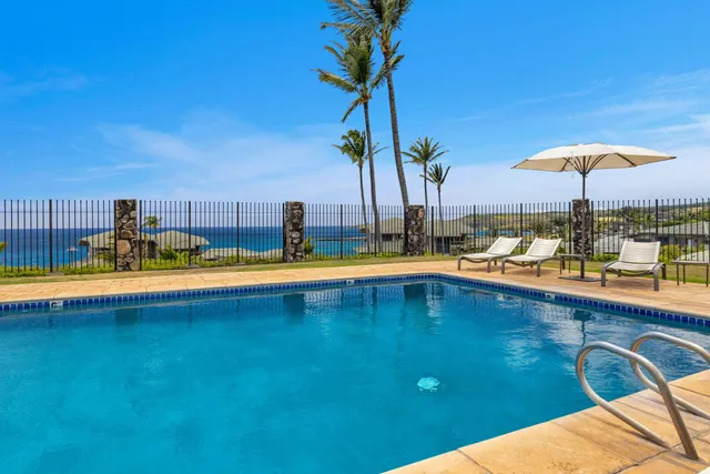 a view of a swimming pool with a lounge chair