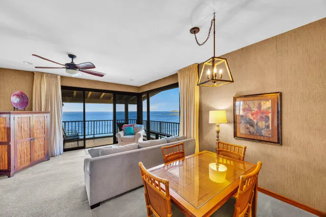 a dining room with furniture and a floor to ceiling window