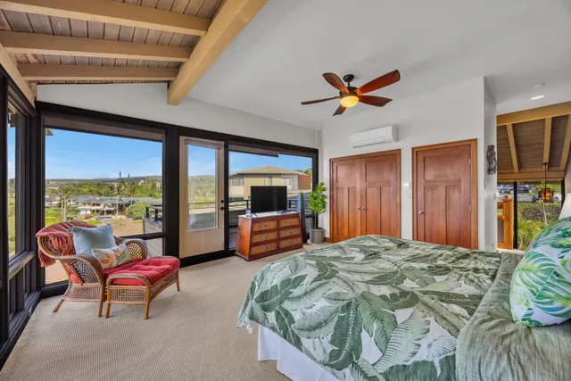 a bedroom with furniture and a large window