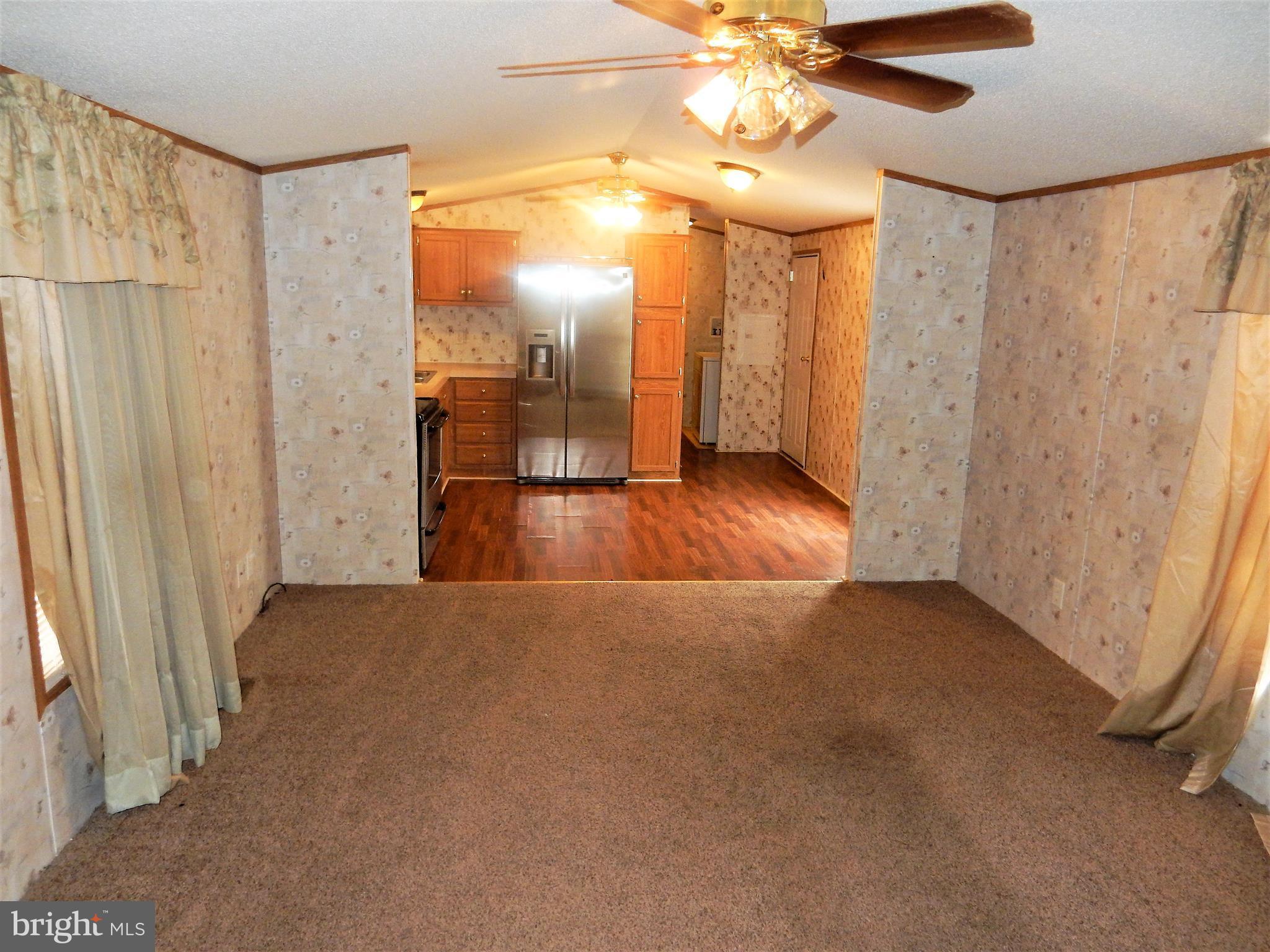 8545 Pulaski Highway Rosedale, MD 21237 - Photo 3 of 17 a view of empty room with wooden floor and fan