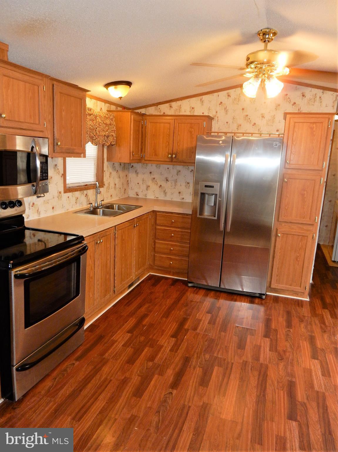 8545 Pulaski Highway Rosedale, MD 21237 - Photo 5 of 17 a kitchen with granite countertop a stove and a refrigerator