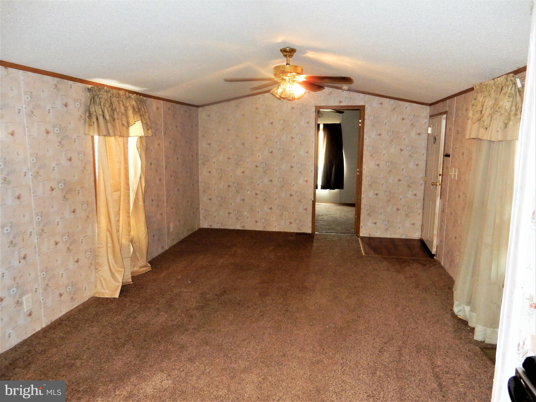 8545 Pulaski Highway Rosedale, MD 21237 - Photo 7 of 17 a view of a big room with closet and chandelier fan
