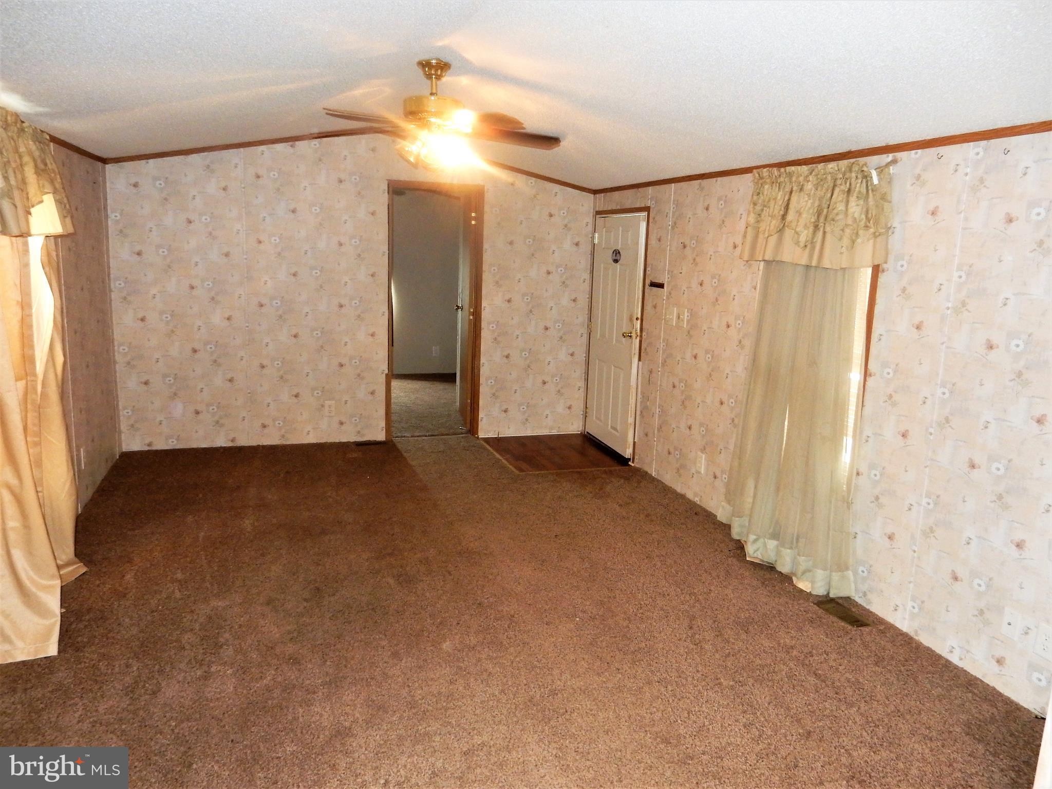8545 Pulaski Highway Rosedale, MD 21237 - Photo 8 of 17 a view of a room with a walk in closet and wooden floor