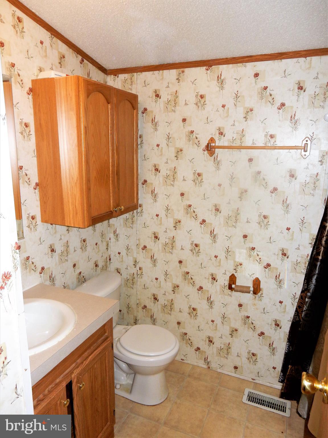 8545 Pulaski Highway Rosedale, MD 21237 - Photo 10 of 17 a bathroom with a sink toilet and shower
