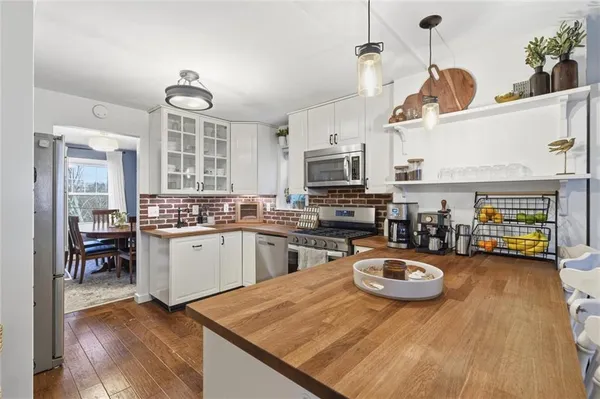 a kitchen with sink refrigerator and microwave