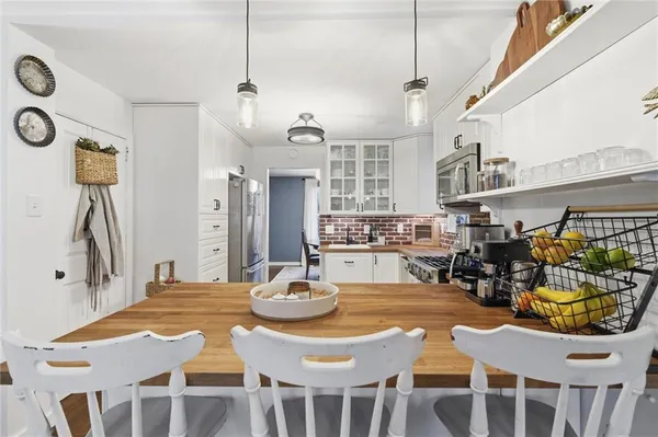 a kitchen with a dining table and chairs