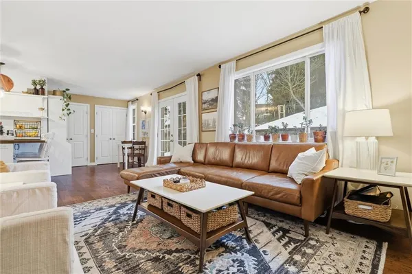a living room with furniture a rug and a large window