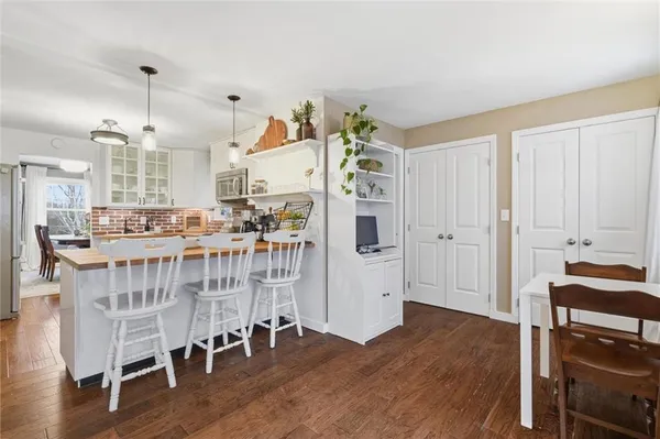 a room with stainless steel appliances wooden floors and view living room