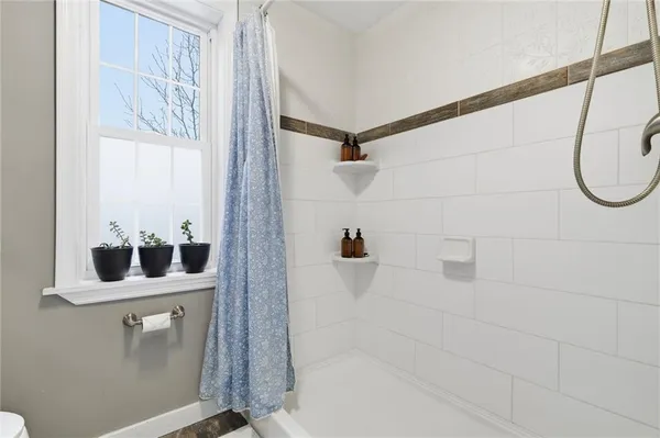 a bathroom with a bathtub and shower