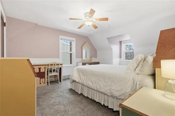 a spacious bedroom with a bed and a chandelier
