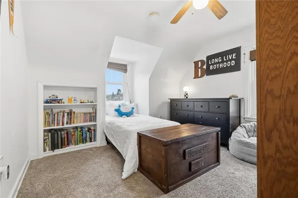 a living room with furniture and a book shelf