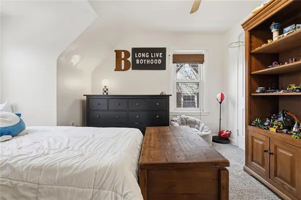 a bedroom with a bed and a dresser
