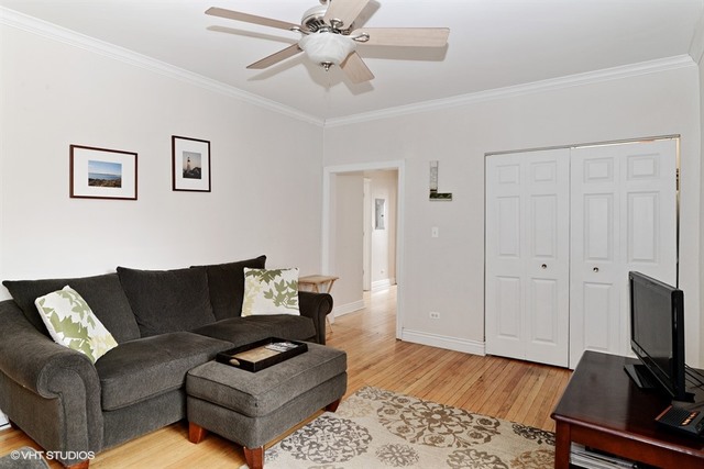 2448 West Addison Street, Unit OB Chicago, IL 60618 - Photo 4 of 5 a living room with furniture and wooden floor