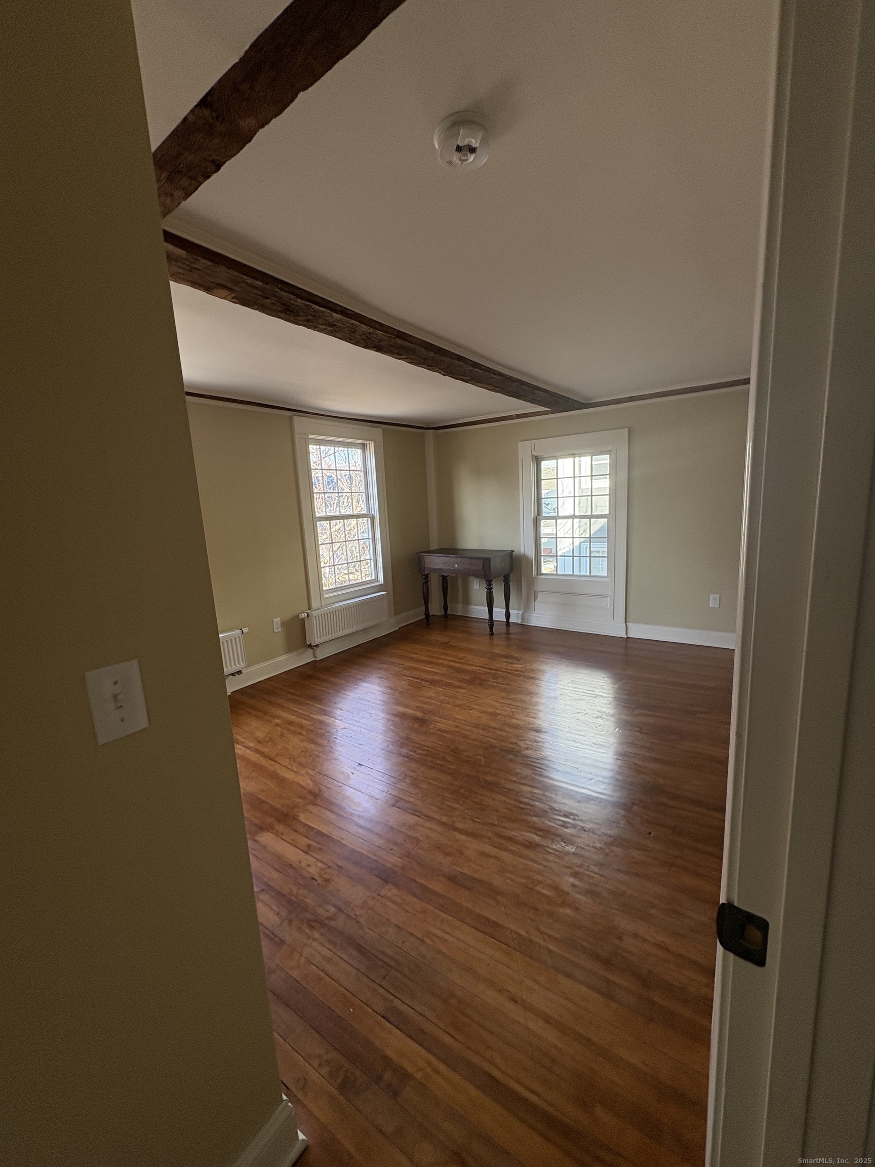 7 Coit Street, Unit 2 New London, CT 06320 - Photo 14 of 19 a view of empty room with wooden floor and fireplace