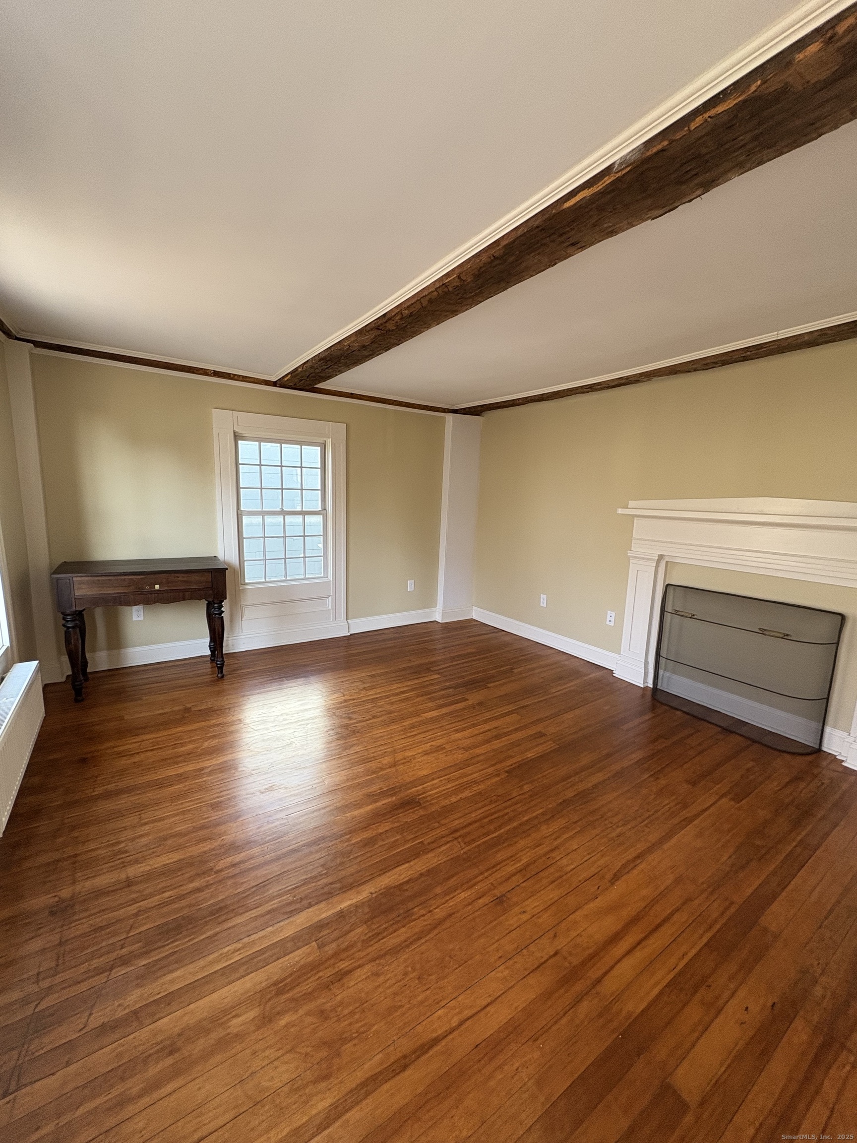 7 Coit Street, Unit 2 New London, CT 06320 - Photo 4 of 19 a view of empty room with wooden floor and fan