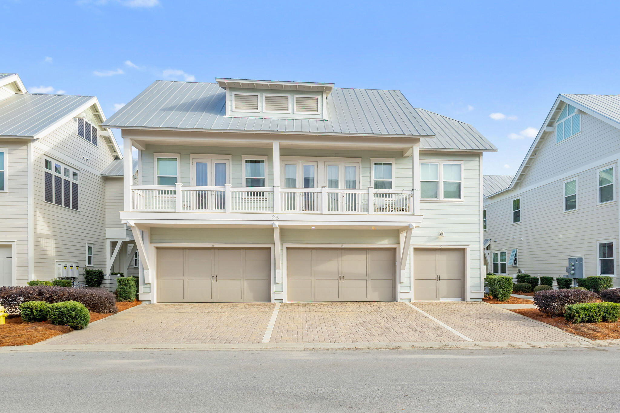 26 East E Pine, Unit A Inlet Beach, FL 32461 - Photo 2 of 53 a front view of a house with a yard and garage