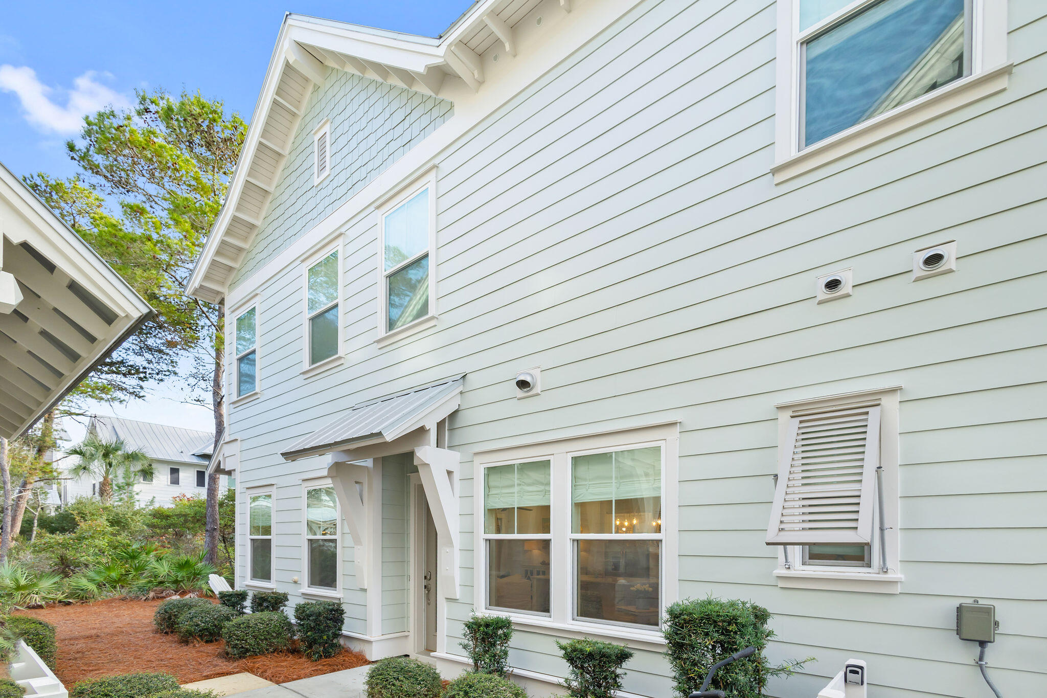 26 East E Pine, Unit A Inlet Beach, FL 32461 - Photo 3 of 53 a view of a white house next to a yard
