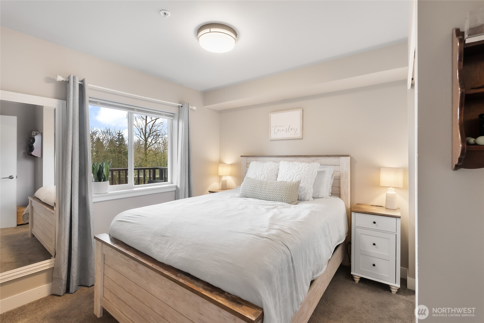 1882 Front Street, Unit 302 Lynden, WA 98264 - Photo 11 of 31 a bedroom with a large bed and a flat tv screen on dresser