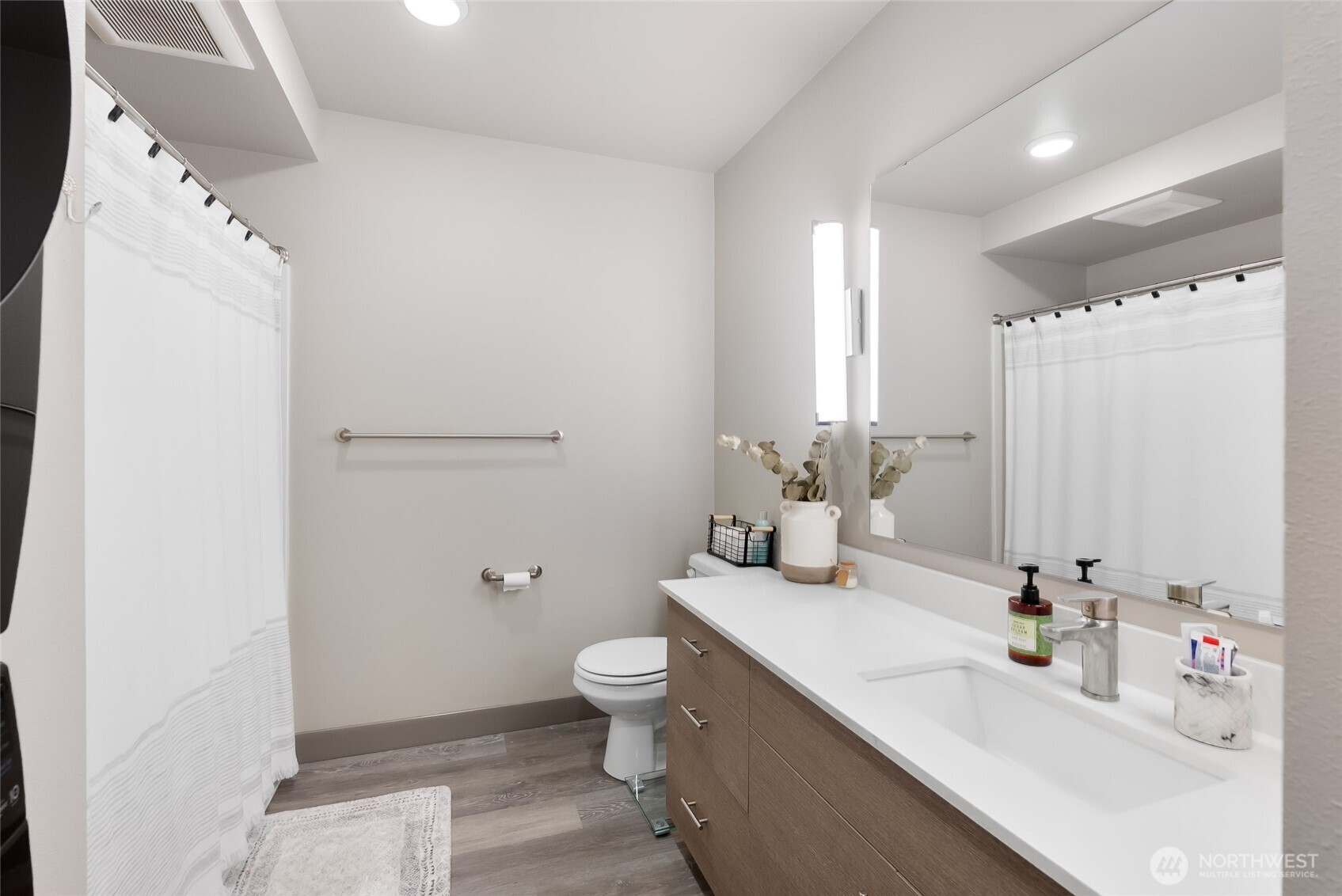 1882 Front Street, Unit 302 Lynden, WA 98264 - Photo 14 of 31 a bathroom with a toilet sink and mirror