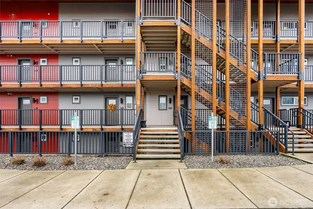 a front view of a building with glass windows and a street