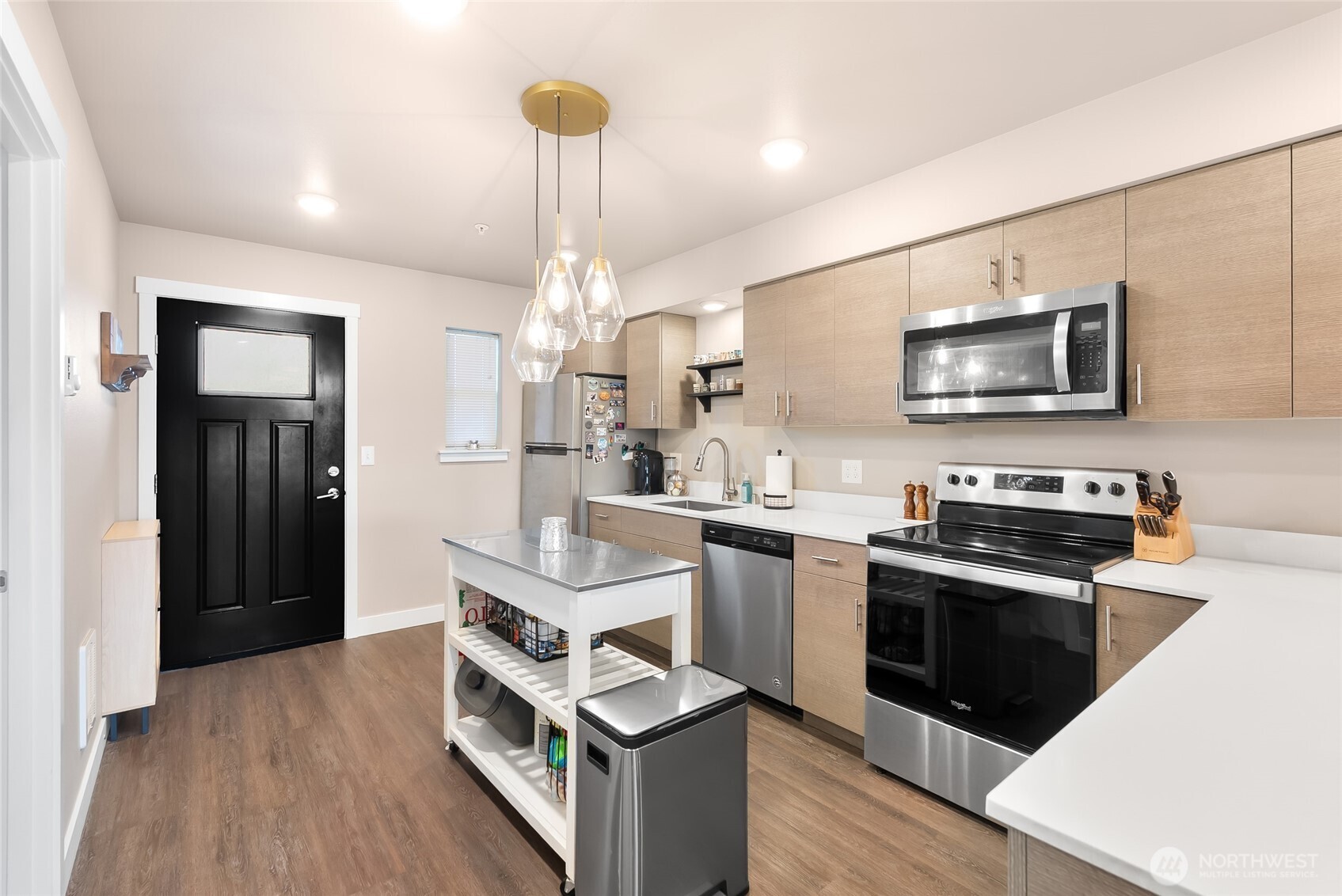 1882 Front Street, Unit 302 Lynden, WA 98264 - Photo 4 of 31 a kitchen with stainless steel appliances a stove refrigerator and microwave
