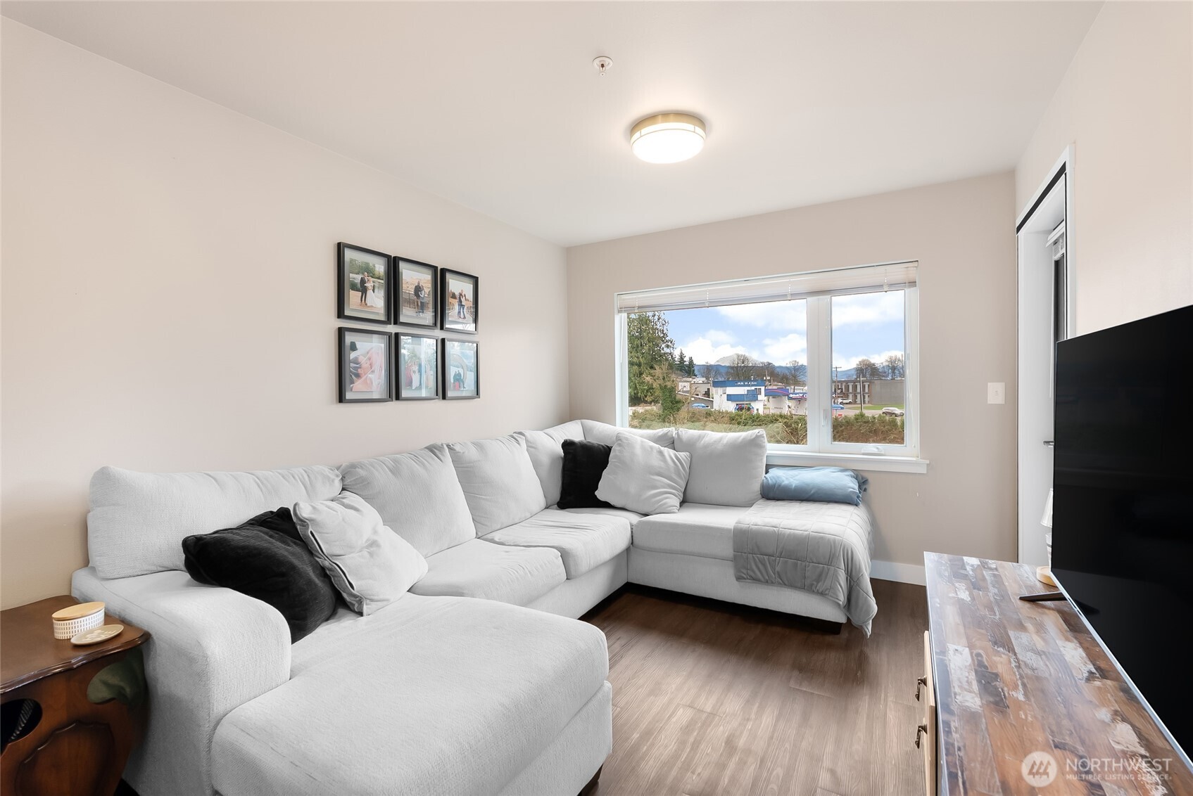 1882 Front Street, Unit 302 Lynden, WA 98264 - Photo 5 of 31 a living room with furniture flat screen tv and a large window